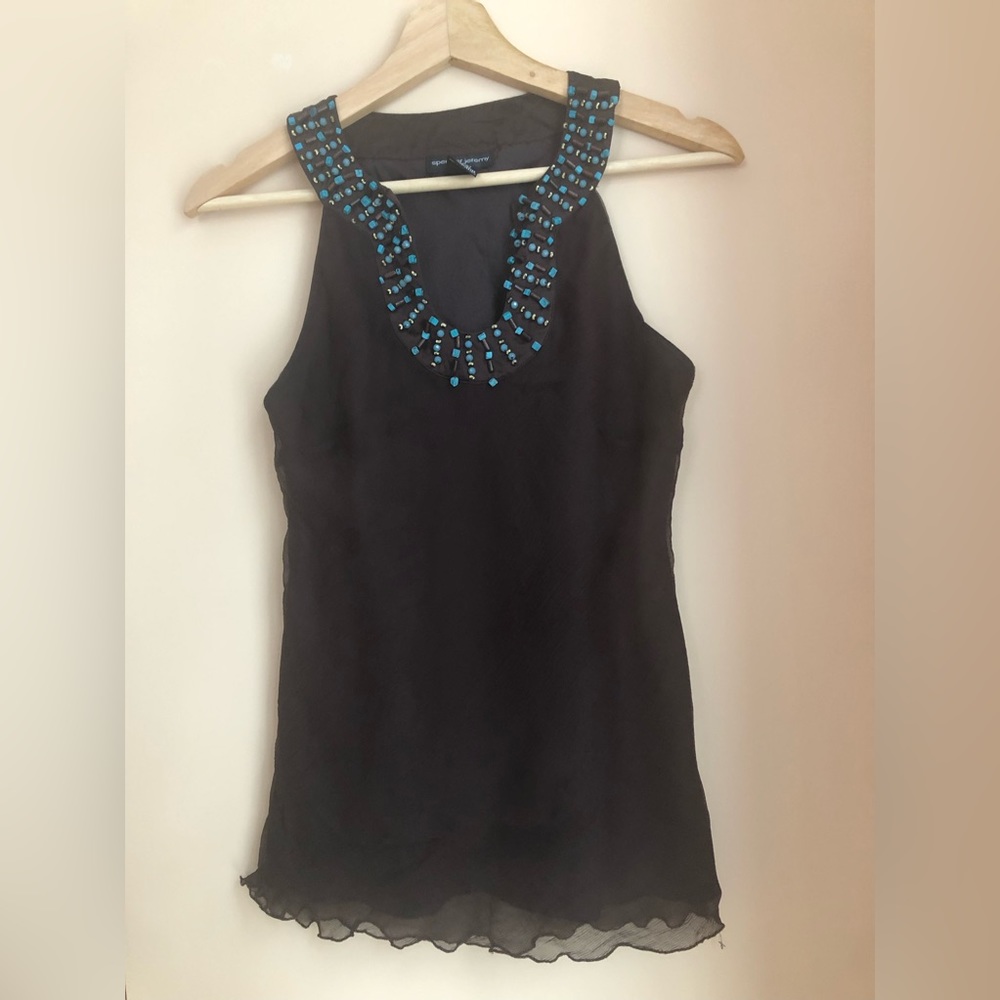 Beautiful sleeveless blouse in tulle with turquoise beads.